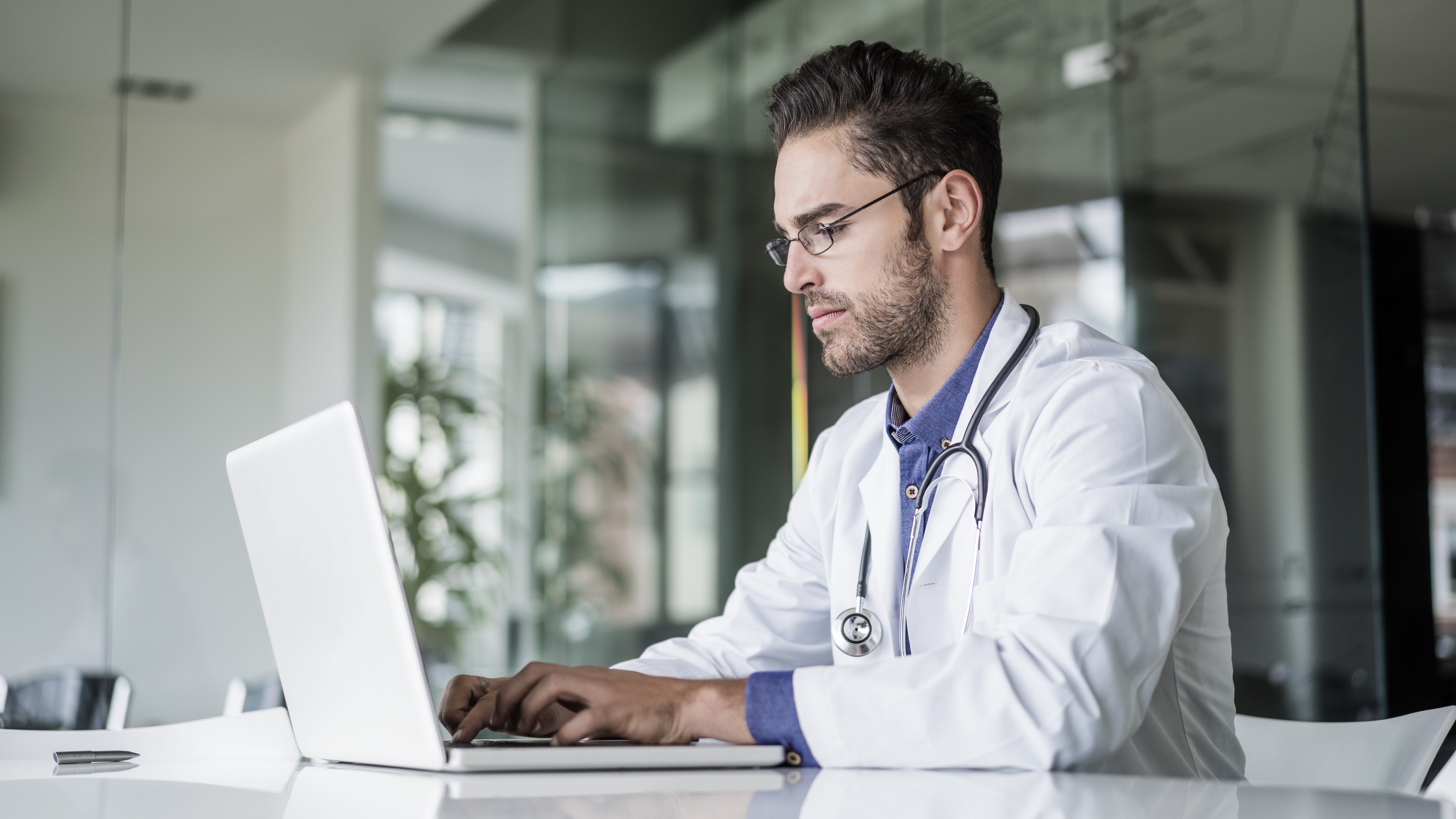 Physician on computer analyzing results